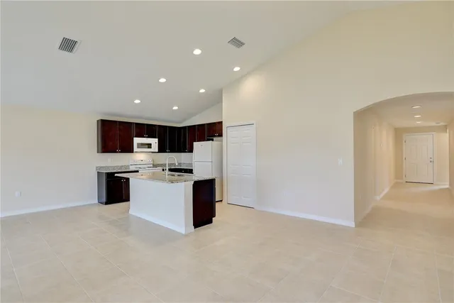 a large kitchen with a large counter top appliances and cabinets