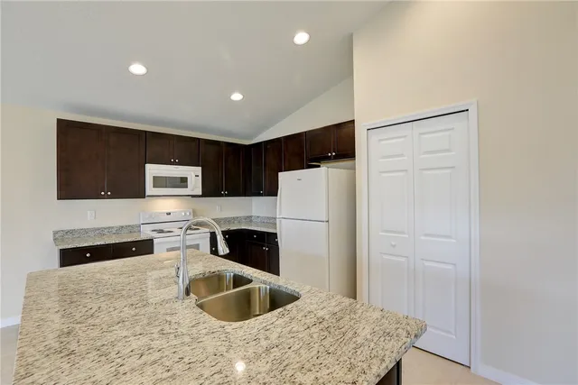 a kitchen with a sink and chandelier