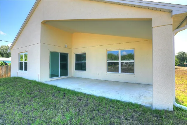 a view of house with backyard