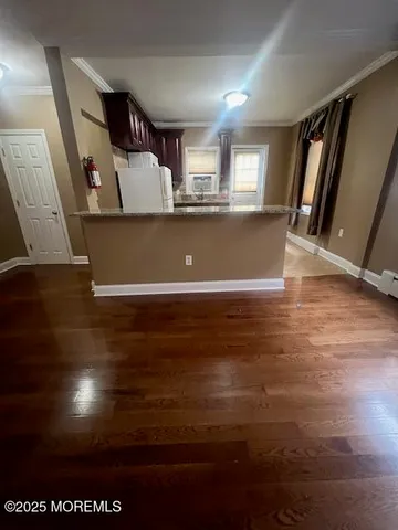 a view of a livingroom with furniture wooden floor and window