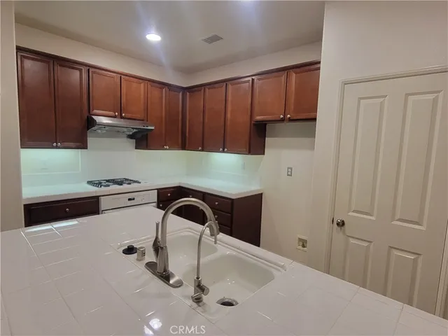 a kitchen with a sink and cabinets