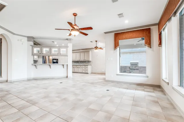 a view of empty room with wooden floor and window