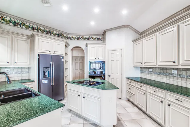 a kitchen with stainless steel appliances granite countertop a refrigerator and stove
