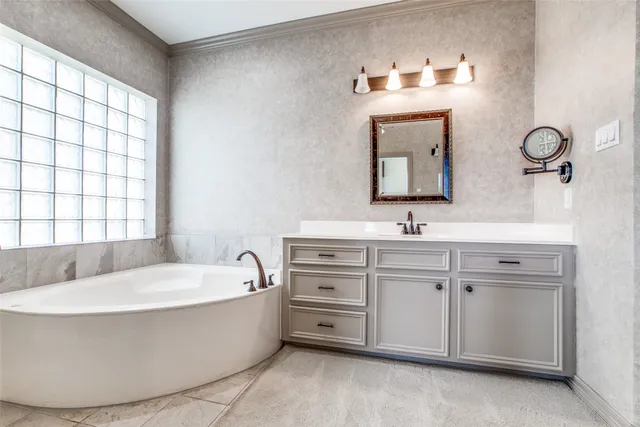 a bathroom with a tub a sink and mirror