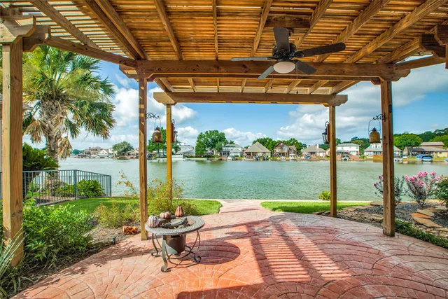 a patio with water view fountain and a yard with plants