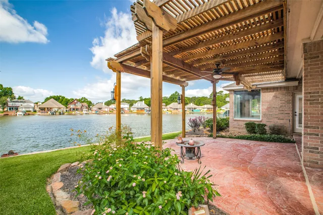 a view of a patio with a table chairs and a backyard