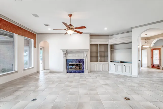 a view of a livingroom with a fireplace and window