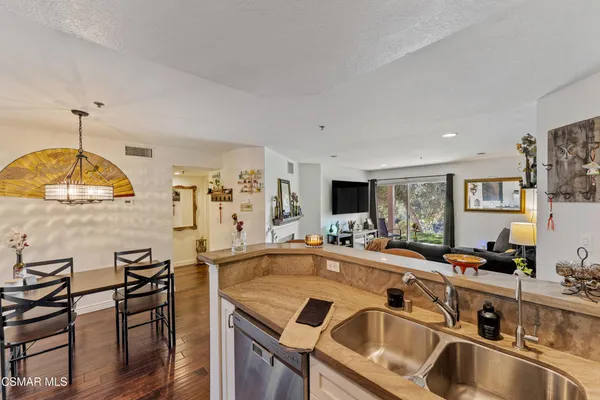 a kitchen with a table chairs sink and cabinets