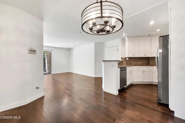 a view of a kitchen with a stove cabinets
