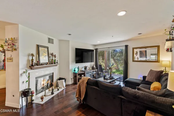 a living room with furniture a fireplace and a flat screen tv