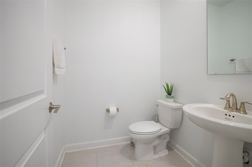 4507 Hillingdam Road Davenport, FL 33837 - Photo 11 of 83 a white toilet sitting next to a bathroom sink