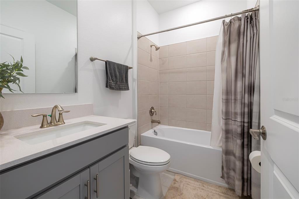 4507 Hillingdam Road Davenport, FL 33837 - Photo 13 of 83 a bathroom with a granite countertop sink toilet and shower