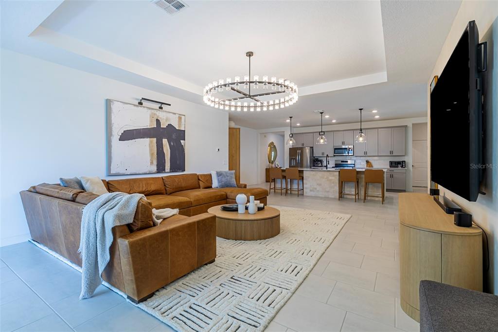 4507 Hillingdam Road Davenport, FL 33837 - Photo 15 of 83 a living room with furniture and a flat screen tv