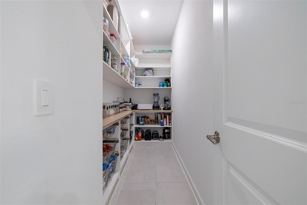 4507 Hillingdam Road Davenport, FL 33837 - Photo 25 of 83 a view of walk in closet with clothes and shoes