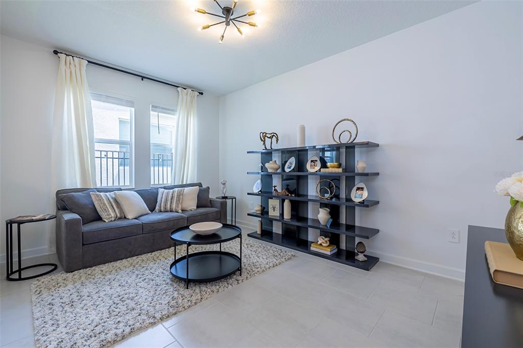 4507 Hillingdam Road Davenport, FL 33837 - Photo 27 of 83 a living room with furniture and a cabinet