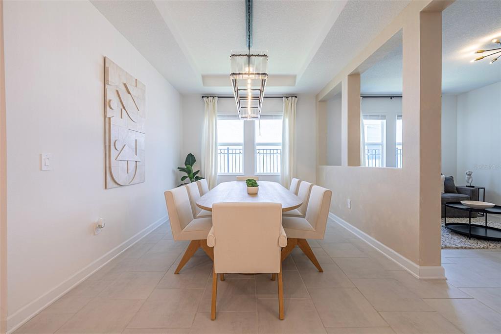 4507 Hillingdam Road Davenport, FL 33837 - Photo 29 of 83 a dining room with furniture a chandelier and window