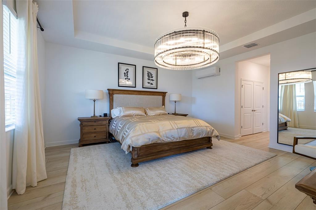 4507 Hillingdam Road Davenport, FL 33837 - Photo 36 of 83 a bedroom with a bed and a mirror