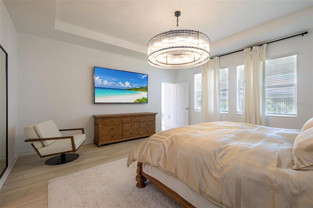 4507 Hillingdam Road Davenport, FL 33837 - Photo 37 of 83 a bedroom with a bed and a chandelier