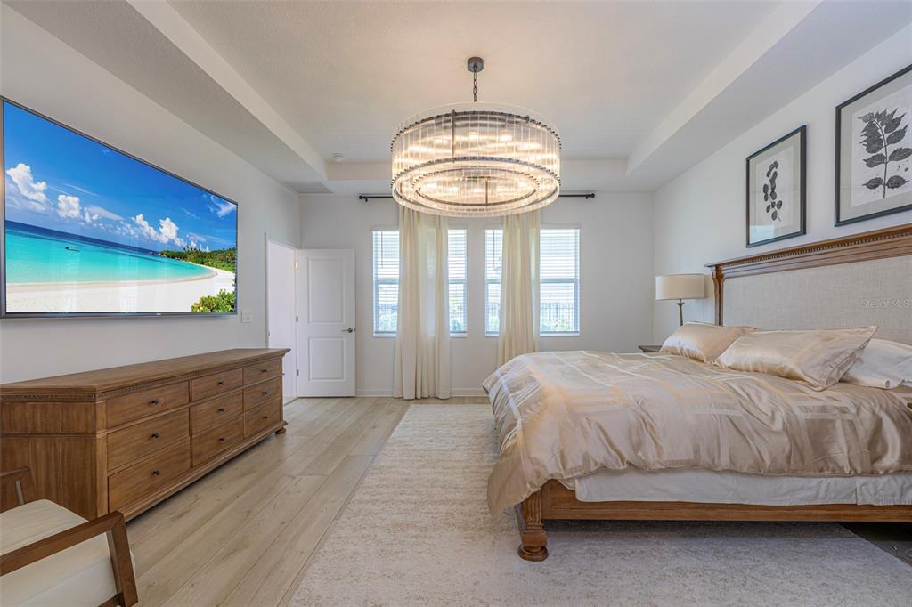 4507 Hillingdam Road Davenport, FL 33837 - Photo 38 of 83 a bedroom with a bed and a chandelier