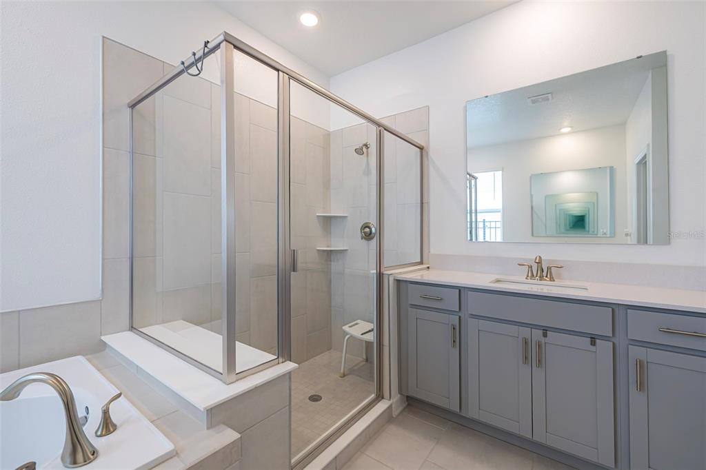 4507 Hillingdam Road Davenport, FL 33837 - Photo 44 of 83 a bathroom with a double vanity sink mirror and shower