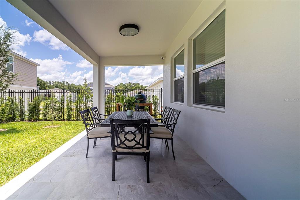 4507 Hillingdam Road Davenport, FL 33837 - Photo 48 of 83 a view of a porch with furniture and garden