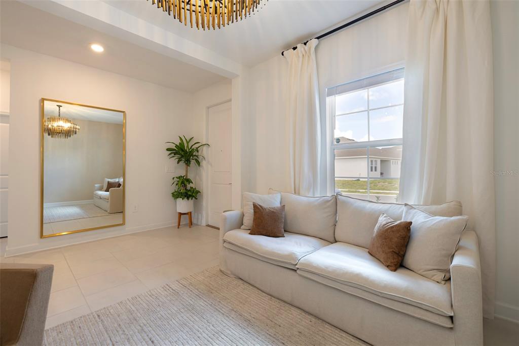 4507 Hillingdam Road Davenport, FL 33837 - Photo 9 of 83 a living room with furniture and a potted plant