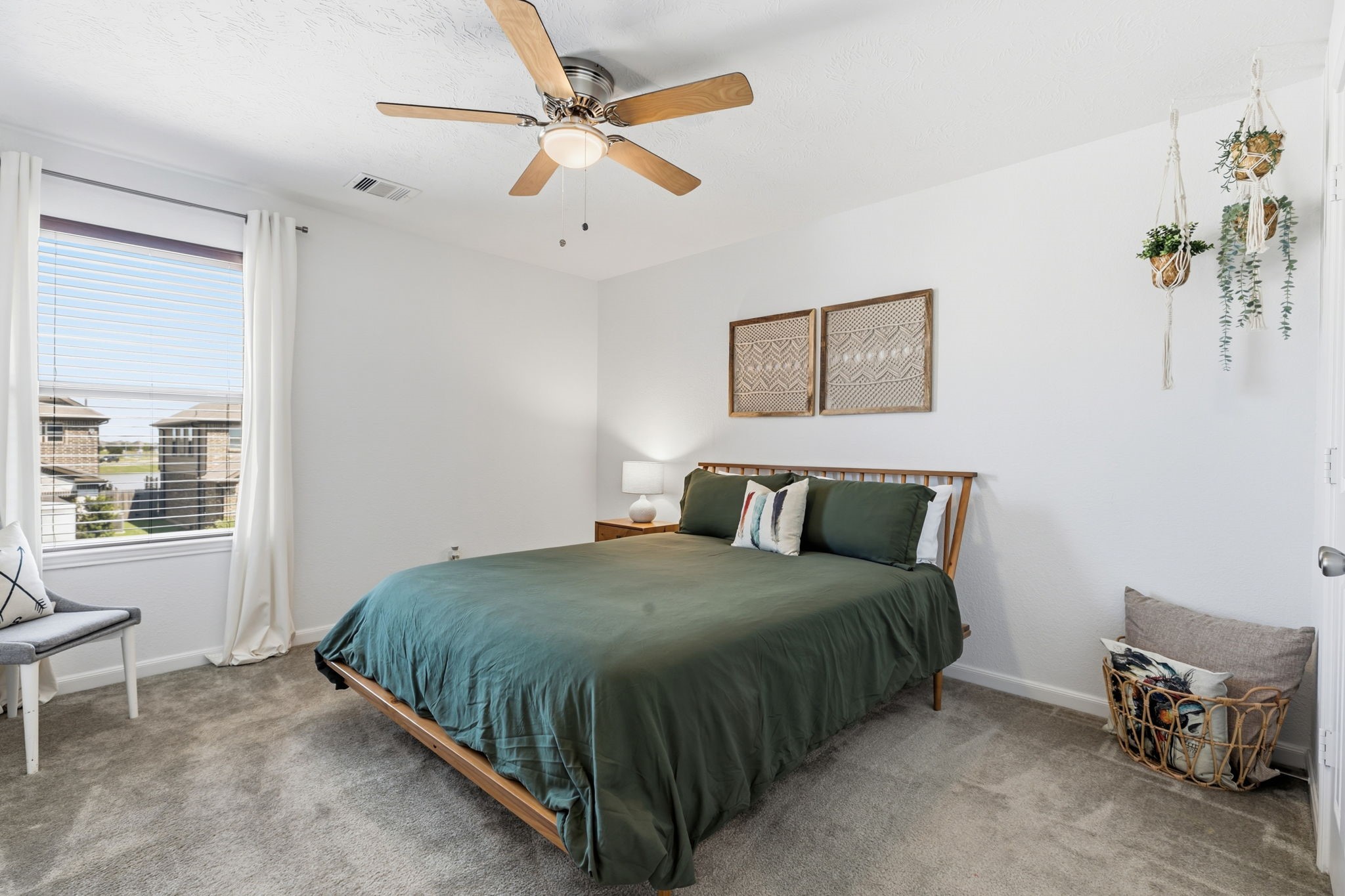 5127 Avondale Rise Street Katy, TX 77493 - Photo 32 of 47 a bedroom with a bed a window and a chandelier