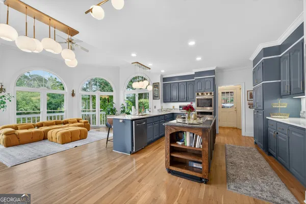 a view of a dining room with furniture wooden floor and chandelier