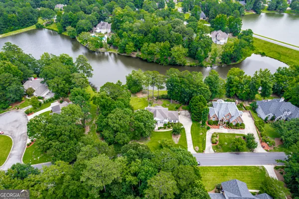 an aerial view of residential house with outdoor space and lake view