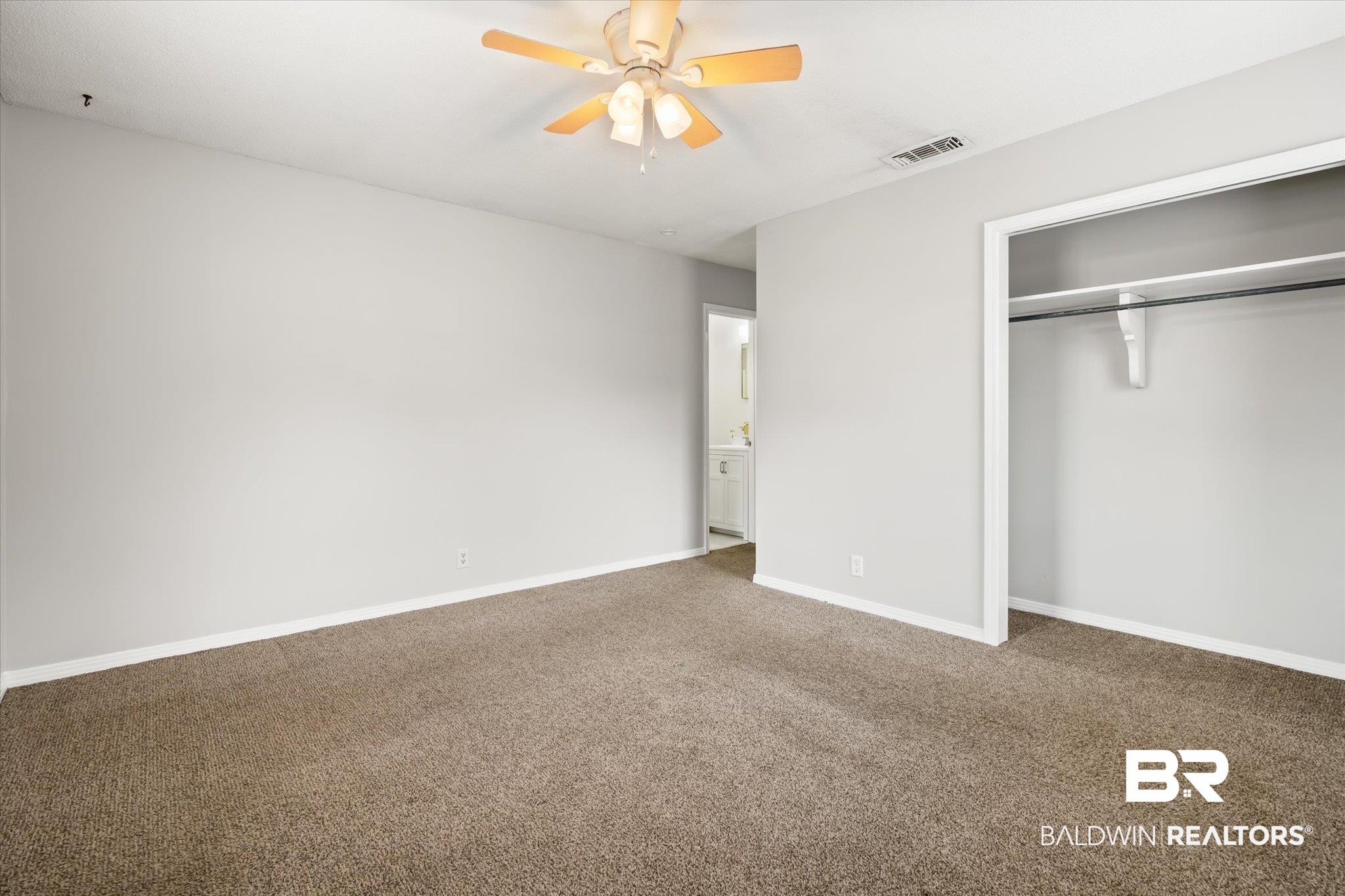 6848 Sandra Drive Theodore, AL 36582 - Photo 3 of 21 Unfurnished bedroom with carpet floors, ceiling fan, and a closet