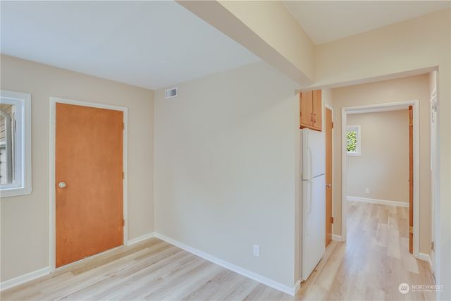 a view of hallway with wooden floor
