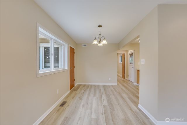 a view of livingroom with hardwood floor and kitchen