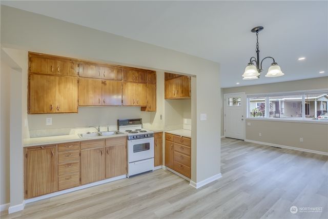 a kitchen with a sink cabinets and window
