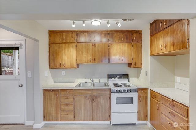 a kitchen with stainless steel appliances a stove microwave and cabinets