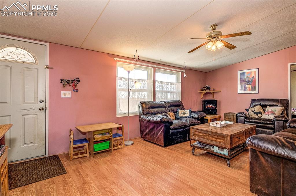 34430 East Jones Road Yoder, CO 80864 - Photo 5 of 41 Lots of Natural Sunlight in Living Room. Laminate Flooring to keep down on Prairie dust!