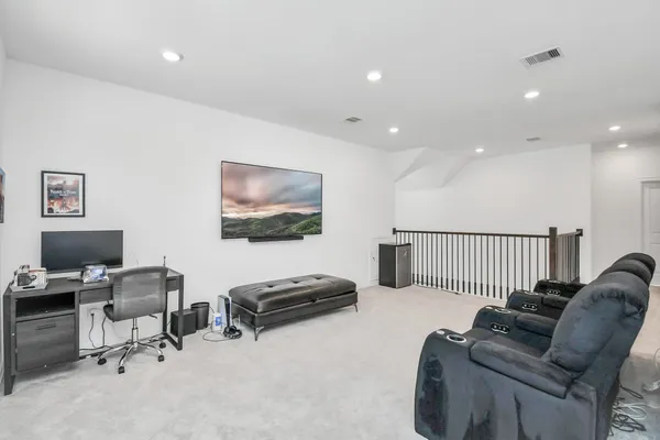 a view of a swimming pool with chairs and table in patio