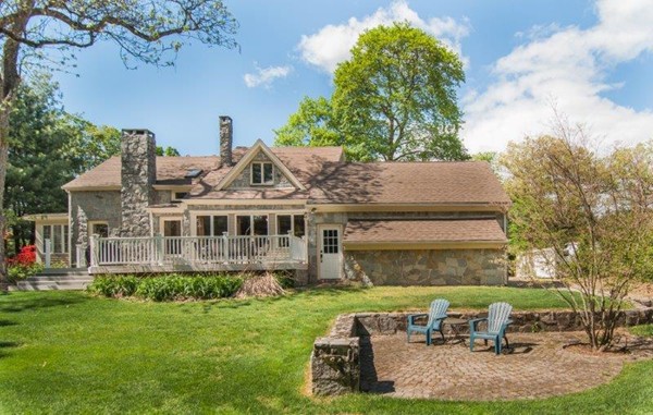 a view of a house with backyard sitting area and garden