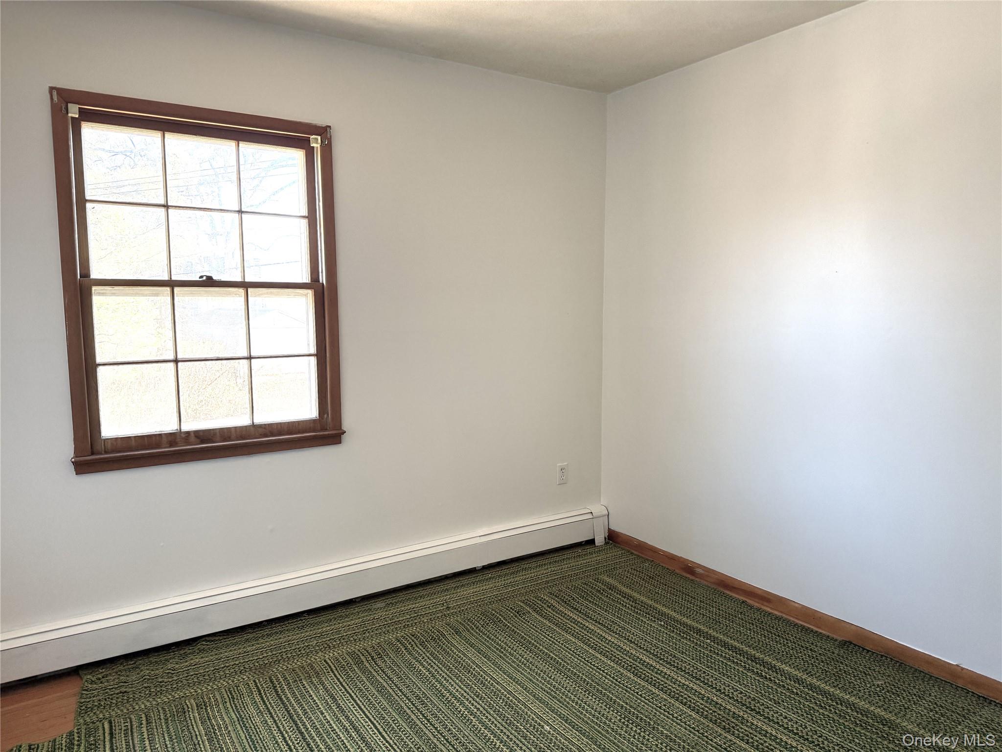 40 Walnut Street Pawling, NY 12564 - Photo 16 of 27 an empty room with wooden floor and windows