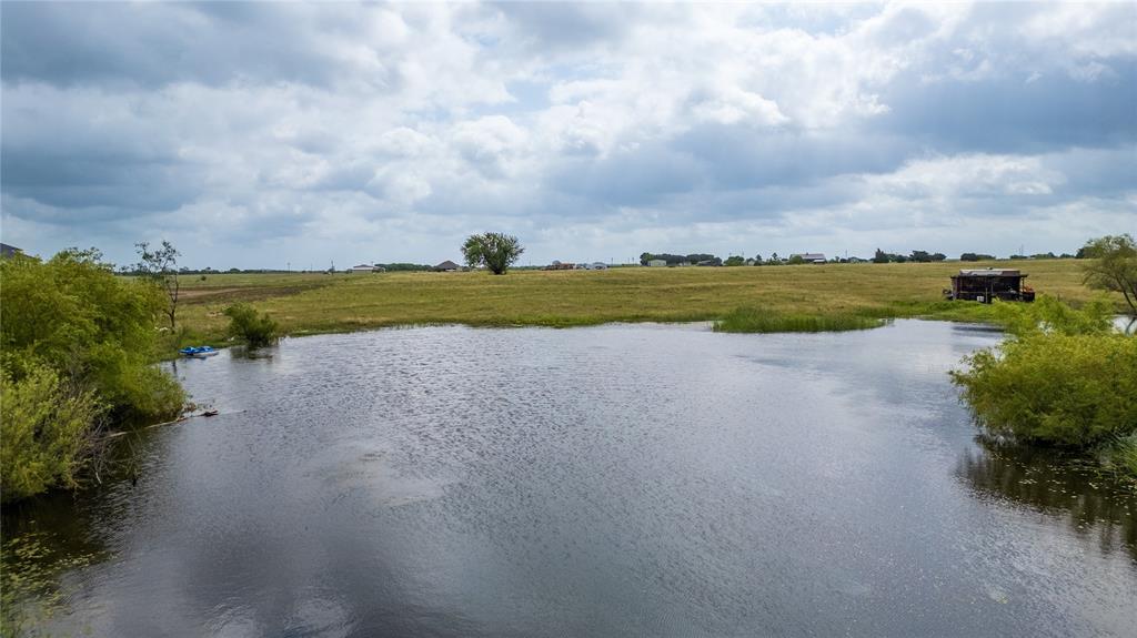 340 Stevens Road Ennis, TX 75119 - Photo 15 of 18 a view of a lake with houses in the back