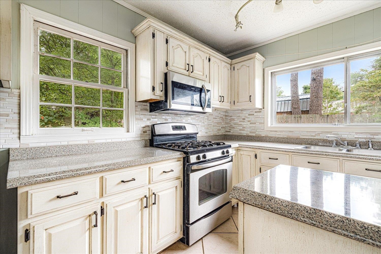 210 Kinney Avenue Covington, TN 38019 - Photo 14 of 28 a kitchen with cabinets stainless steel appliances and a window