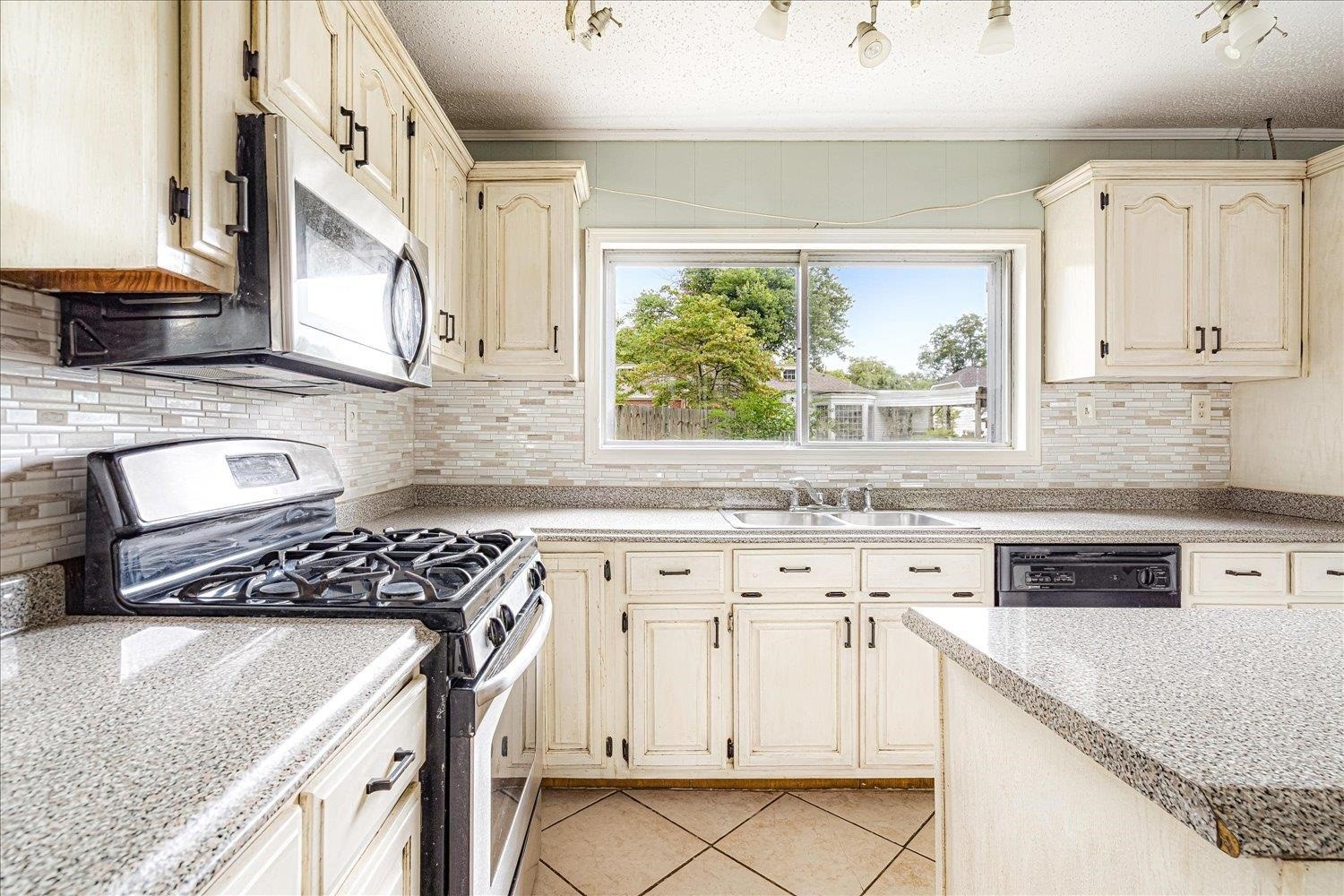 210 Kinney Avenue Covington, TN 38019 - Photo 16 of 28 a kitchen with granite countertop a sink a stove and cabinets