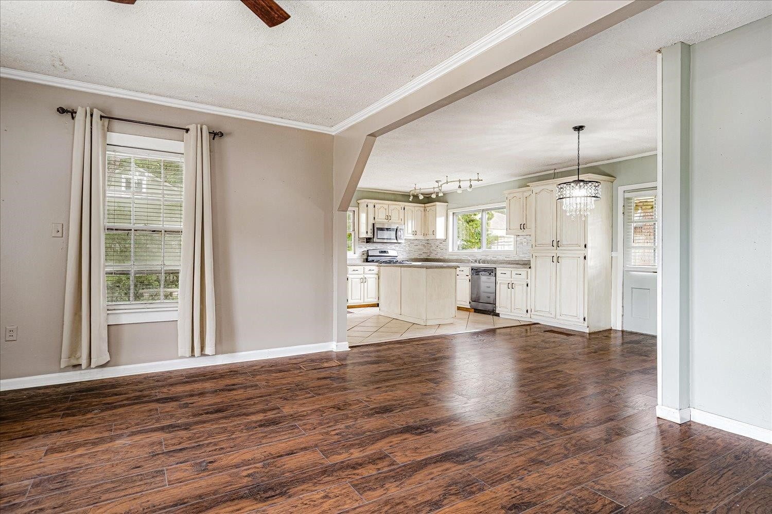 210 Kinney Avenue Covington, TN 38019 - Photo 7 of 28 a view of a kitchen with wooden floor and a window
