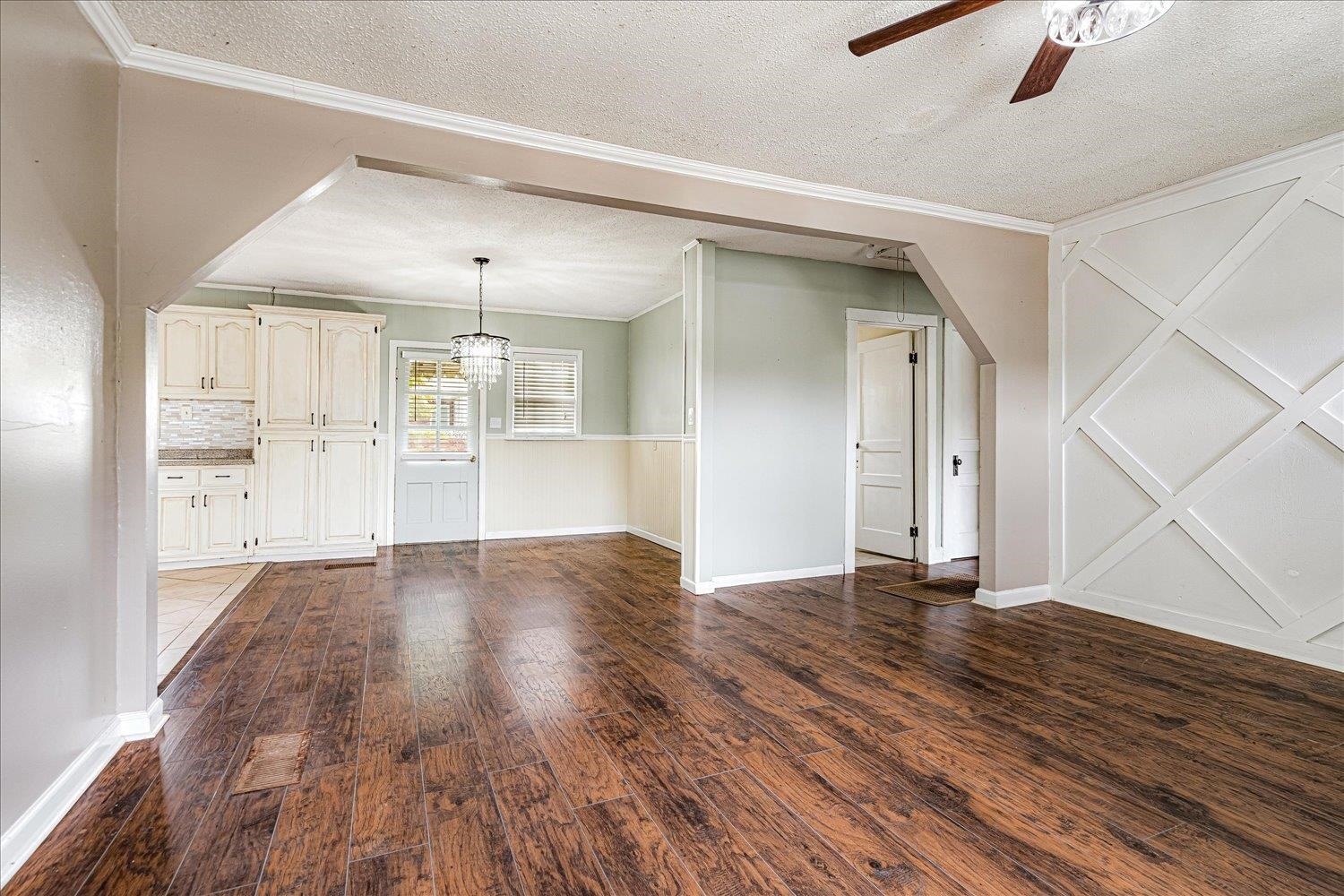 210 Kinney Avenue Covington, TN 38019 - Photo 9 of 28 a view of an empty room with wooden floor and a window