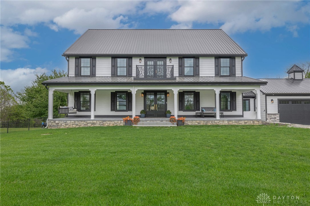 9586 Ferry Road Waynesville, OH 45068 - Photo 1 of 40 This charming home offers a sprawling green lawn and an inviting full-length front porch.