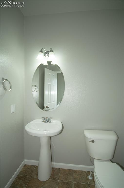 9443 St.George Road Peyton, CO 80831 - Photo 21 of 45 a bathroom with a toilet sink and mirror