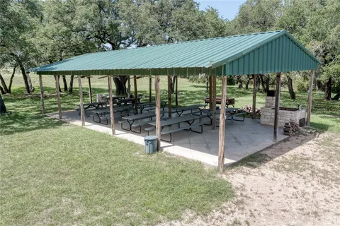 a backyard of a house with yard barbeque oven and outdoor seating