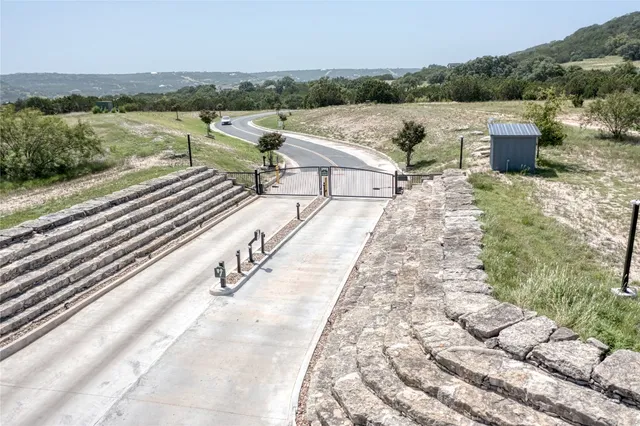 a view of a lake with couches in the outdoor space