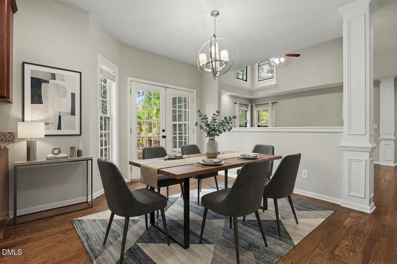1001 Denfield Court Raleigh, NC 27615 - Photo 3 of 44 a view of a dining room with furniture a chandelier and wooden floor