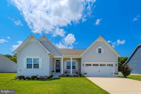 a view of a swimming pool with sitting area and slide