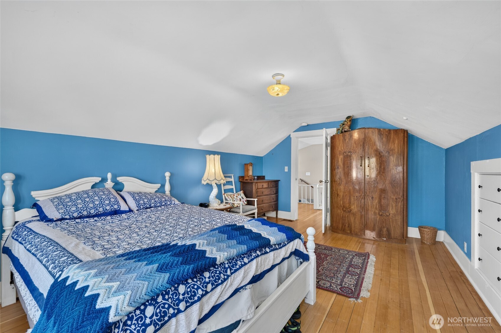 237 West 3rd Street Port Angeles, WA 98362 - Photo 32 of 40 a bedroom with a bed and wooden floor